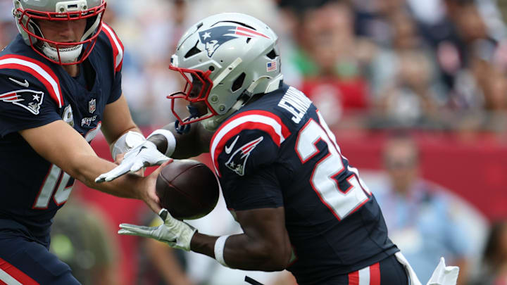 Nov 9, 2025; Tampa, Florida, USA; New England Patriots quarterback Drake Maye (10) hands the ball off to running back Terrell Jennings (26) during the second quarter against the Tampa Bay Buccaneers at Raymond James Stadium. Mandatory Credit: Nathan Ray Seebeck-Imagn Images