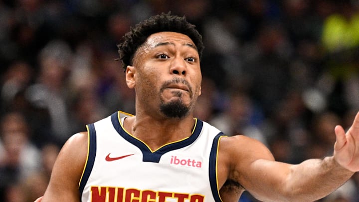 Jan 14, 2026; Dallas, Texas, USA; Denver Nuggets guard Jalen Pickett (24) passes the ball by Dallas Mavericks guard Ryan Nembhard (9) during the second quarter at the American Airlines Center. Mandatory Credit: Jerome Miron-Imagn Images