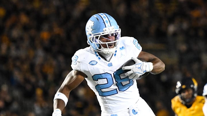 Oct 17, 2025; Berkeley, California, USA; North Carolina Tar Heels running back Benjamin Hall (28) evades tackle by California Golden Bears defensive back Aiden Manutai (14) before running for a touchdown in the first quarter at California Memorial Stadium. Mandatory Credit: Eakin Howard-Imagn Images