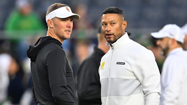 Oct 14, 2023; South Bend, Indiana, USA; USC Trojans head coach Lincoln Riley and Notre Dame Fighting Irish head coach Marcus Freeman chat before the game at Notre Dame Stadium. Mandatory Credit: Matt Cashore-Imagn Images Oct 14, 2023; South Bend, Indiana, USA; USC Trojans head coach Lincoln Riley and Notre Dame Fighting Irish head coach Marcus Freeman chat before the game at Notre Dame Stadium. Mandatory Credit: Matt Cashore-Imagn Images