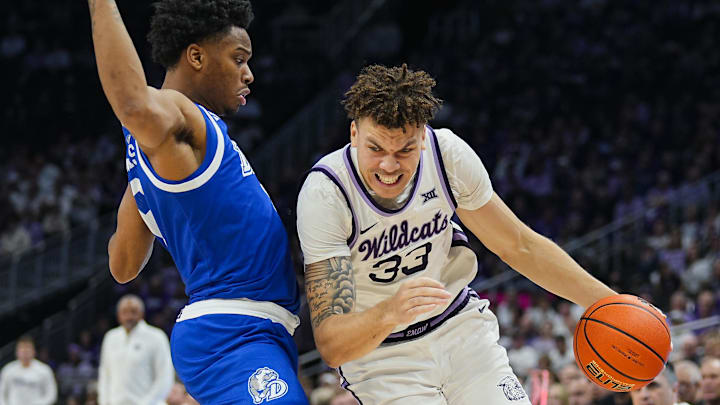 Dec 17, 2024; Kansas City, Missouri, USA; Kansas State Wildcats guard Coleman Hawkins (33) drives against Drake Bulldogs guard Tavion Banks (6) at T-Mobile Center. Mandatory Credit: Jay Biggerstaff-Imagn Images Dec 17, 2024; Kansas City, Missouri, USA; Kansas State Wildcats guard Coleman Hawkins (33) drives against Drake Bulldogs guard Tavion Banks (6) at T-Mobile Center. Mandatory Credit: Jay Biggerstaff-Imagn Images