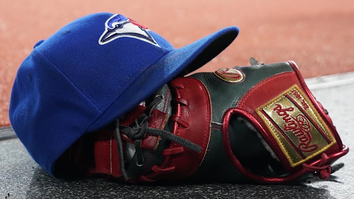 Apr 16, 2024; Toronto, Ontario, CAN; A Toronto Blue Jays hat and glove before the start of the game against the New York Yankees  at Rogers Centre.