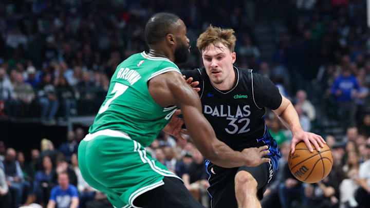Feb 3, 2026; Dallas, Texas, USA;  Dallas Mavericks forward Cooper Flagg (32) controls the ball as Boston Celtics guard Jaylen Brown (7) defends during the first quarter at American Airlines Center. Mandatory Credit: Kevin Jairaj-Imagn Images