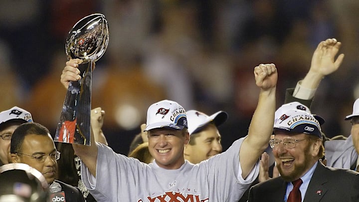 Tampa Bay Buccaneers head coach Jon Gruden raises the Vince Lombardi Trophy next to owner Malcolm Glazer.