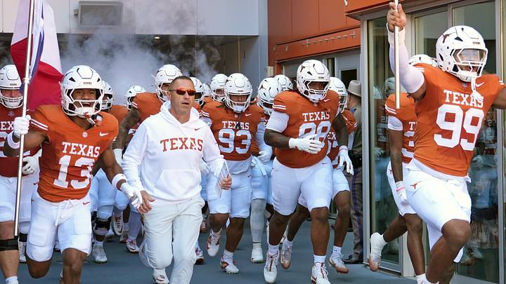 Texas Longhorns Head Coach Steve Sarkisian and players enter the field at Darrell K Royal-Texas Memorial Stadium before a game against the Florida Gators