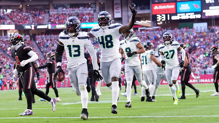 Dec 8, 2024; Glendale, Arizona, USA; Seattle Seahawks linebacker Ernest Jones IV (13) celebrates an interception against the Arizona Cardinals during the first half at State Farm Stadium.