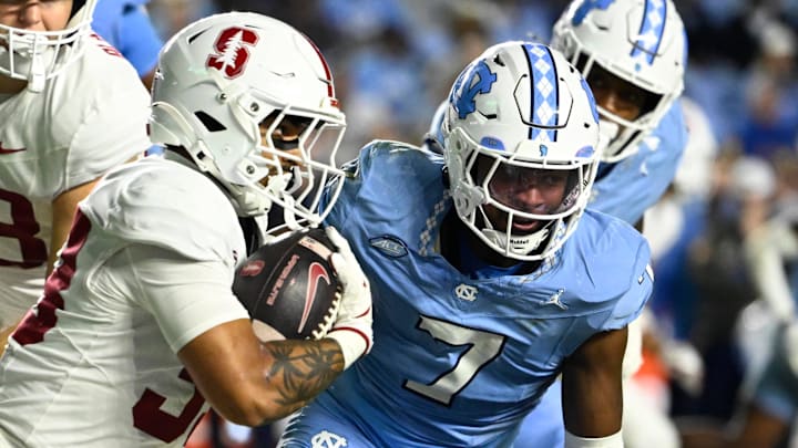Nov 8, 2025; Chapel Hill, North Carolina, USA;  Stanford Cardinal running back Cole Tabb (33) with the ball as North Carolina Tar Heels linebacker Khmori House (7) defends in the third quarter at Kenan Stadium. Mandatory Credit: Bob Donnan-Imagn Images
