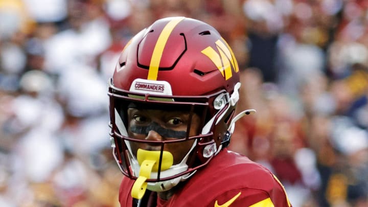 Washington Commanders wide receiver Terry McLaurin runs the ball as Las Vegas Raiders safety Isaiah Pola-Mao defends