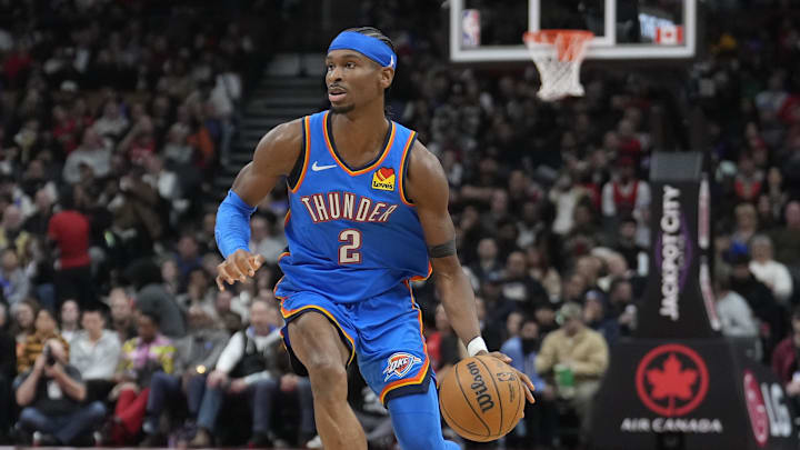 Dec 5, 2024; Toronto, Ontario, CAN; Oklahoma City Thunder guard Shai Gilgeous-Alexander (2) dribbles the ball against the Toronto Raptors during the second half at Scotiabank Arena. Mandatory Credit: John E. Sokolowski-Imagn Images