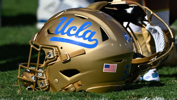 Nov 30, 2024; Pasadena, California, USA; UCLA Bruins helmets during pregame warmups before playing the Fresno State Bulldogs at Rose Bowl. Mandatory Credit: Robert Hanashiro-Imagn Images