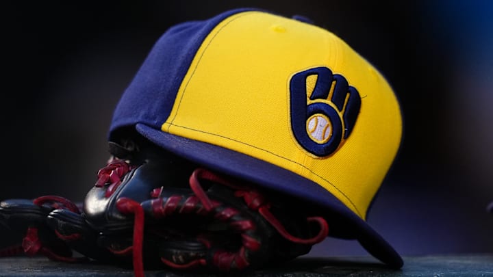 Jul 3, 2024; Denver, Colorado, USA; Detailed view of a Milwaukee Brewers cap and glove during the game against the Colorado Rockies at Coors Field. Mandatory Credit: Ron Chenoy-Imagn Images