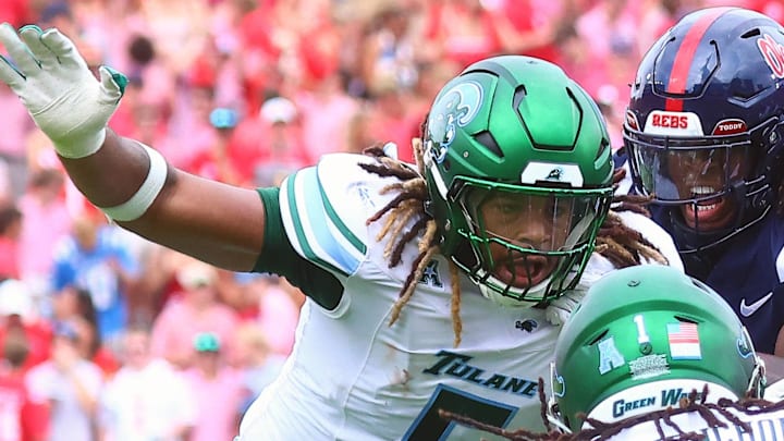 Sep 20, 2025; Oxford, Mississippi, USA; Mississippi Rebels running back Kewan Lacy (5) runs the ball as Tulane Green Wave defensive end Harvey Dyson (5) and Tulane Green Wave defensive back Jack Tchienchou (1) attempt to make the tackle during the first quarter at Vaught-Hemingway Stadium. Mandatory Credit: Petre Thomas-Imagn Images