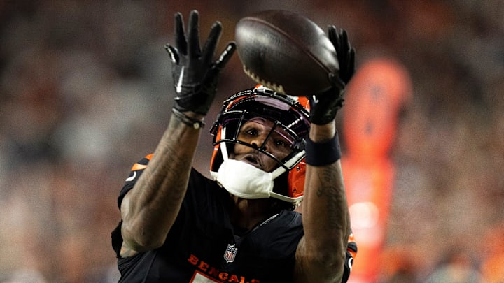 Cincinnati Bengals wide receiver Tee Higgins (5) catches a pass inside the 5-yard line as Denver Broncos cornerback Riley Moss (21) defends in overtime of the NFL game at Paycor Stadium in Cincinnati on Saturday, Dec. 28, 2024.