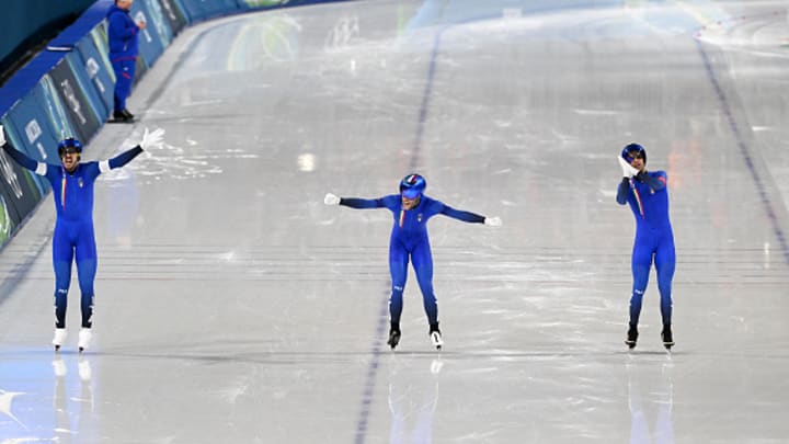 Davide Ghiotto, Michell Malfatti and Andrea Giovannini celebrate winning gold. 