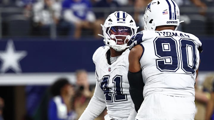 Dallas Cowboys defensive ends Donovan Ezeiruaku and Solomon Thomas celebrate after a sack against the Washington Commanders