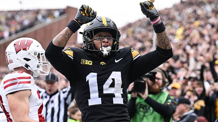 Oct 31, 2026; Iowa City, Iowa, USA;  Iowa Hawkeyes wide receiver Tony Diaz (14) reacts after scoring a touchdown as Wisconsin Badgers linebacker Cooper Catalano (44) looks on during the second quarter at Kinnick Stadium.  Mandatory Credit: Jeffrey Becker-Imagn Images