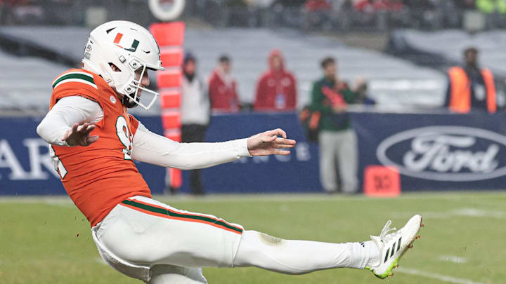 Dec 28, 2023; Bronx, NY, USA; Rutgers Scarlet Knights defensive back Todd Bowles Jr. (19) blocks a punt by Miami Hurricanes punter Dylan Joyce (94) during the second half of the 2023 Pinstripe Bowl at Yankee Stadium. Mandatory Credit: Vincent Carchietta-Imagn Images