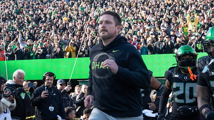 Oregon coach Dan Lanning leads his team onto the field for their game against Southern California Nov. 22, 2025.