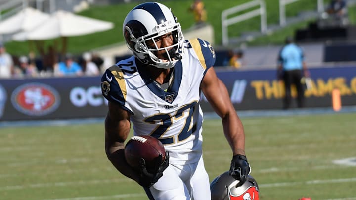 Sep 29, 2019; Los Angeles, CA, USA; Los Angeles Rams cornerback Marcus Peters (22) runs back an interception as Tampa Bay Buccaneers tight end O.J. Howard (80) tries to make a tackle during the 2nd half at Los Angeles Memorial Coliseum. Mandatory Credit: Robert Hanashiro-Imagn Images