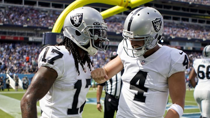 Las Vegas Raiders receiver Davante Adams and quarterback Derek Carr celebrate a touchdown.
