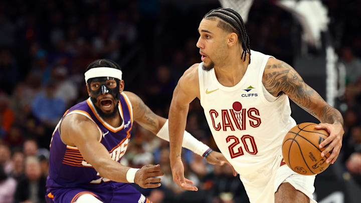 Jan 30, 2026; Phoenix, Arizona, USA; Cleveland Cavaliers guard Jaylon Tyson (20) moves the ball against Phoenix Suns guard Jordan Goodwin (23) in the first half at Mortgage Matchup Center. Mandatory Credit: Mark J. Rebilas-Imagn Images