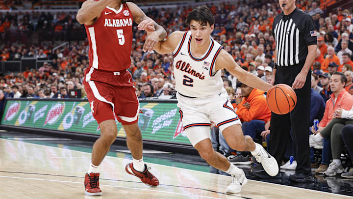Nov 19, 2025; Chicago, Illinois, USA; Illinois Fighting Illini guard Andrej Stojakovic (2) drives to the basket against Alabama Crimson Tide forward Amari Allen (5) during the first half at United Center. Mandatory Credit: Kamil Krzaczynski-Imagn Images