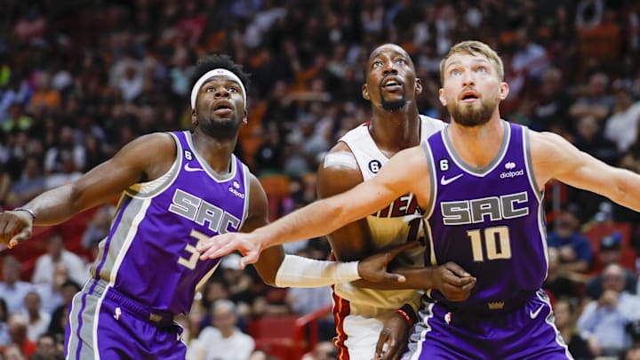 Nov 2, 2022; Miami, Florida, USA; Sacramento Kings forward Domantas Sabonis (10) an guard Terence Davis (3) defend Miami Heat center Bam Adebayo (13) during the fourth quarter at FTX Arena. Mandatory Credit: Sam Navarro-Imagn Images