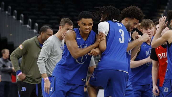 Mar 26, 2026; Washington, DC, USA; Duke Blue Devils guard Caleb Foster (1) and Blue Devils forward Cameron Boozer (12) bump Blue Devils guard Isaiah Evans (3) in a huddle during a practice session ahead of the east regional of the men's 2026 NCAA Tournament at Capital One Arena.