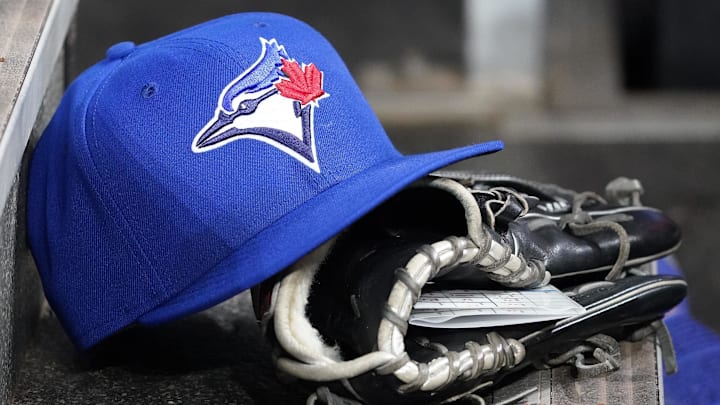 Apr 16, 2025; Toronto, Ontario, CAN; A Toronto Blue Jays hat and glove in the dugout during a game against the Atlanta Braves at Rogers Centre. Apr 16, 2025; Toronto, Ontario, CAN; A Toronto Blue Jays hat and glove in the dugout during a game against the Atlanta Braves at Rogers Centre.