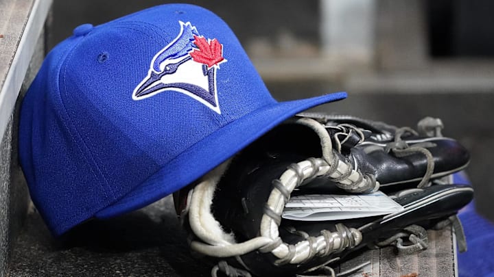 Apr 16, 2025; Toronto, Ontario, CAN; A Toronto Blue Jays hat and glove in the dugout during a game against the Atlanta Braves at Rogers Centre. 