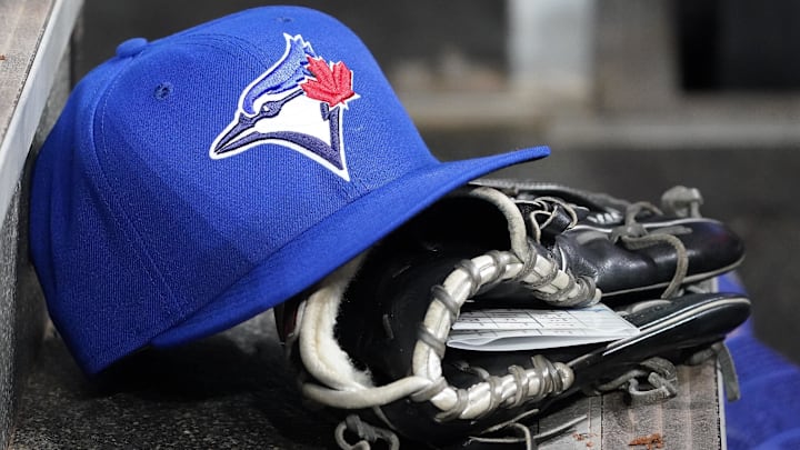 Apr 16, 2025; Toronto, Ontario, CAN; A Toronto Blue Jays hat and glove in the dugout during a game against the Atlanta Braves at Rogers Centre. 