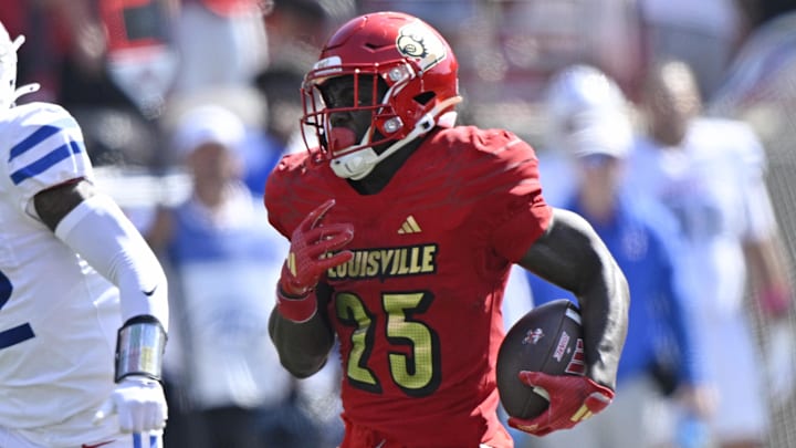 Oct 5, 2024; Louisville, Kentucky, USA;  Louisville Cardinals running back Isaac Brown (25) runs the ball against Southern Methodist Mustangs safety Cale Sanders Jr. (22) during the second half at L&N Federal Credit Union Stadium. 