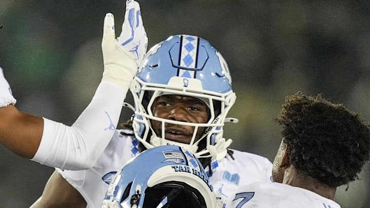 Sep 6, 2025; Charlotte, North Carolina, USA; North Carolina Tar Heels defensive back Greg Smith (12) celebrates his interception with teammates during the second half against the Charlotte 49ers at Jerry Richardson Stadium. Mandatory Credit: Jim Dedmon-Imagn Images