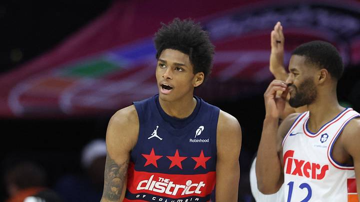Mar 26, 2025; Philadelphia, Pennsylvania, USA; Washington Wizards guard AJ Johnson (5) reacts to his three pointer in front of Philadelphia 76ers guard Jared Butler (12) during the fourth quarter at Wells Fargo Center. Mandatory Credit: Bill Streicher-Imagn Images
