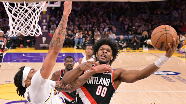 Dec 8, 2024; Los Angeles, California, USA; Los Angeles Lakers forward Anthony Davis (3) defends a shot by Portland Trail Blazers guard Scoot Henderson (00) in the first half at Crypto.com Arena. Mandatory Credit: Jayne Kamin-Oncea-Imagn Images