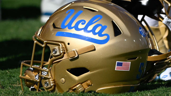 Nov 30, 2024; Pasadena, California, USA; UCLA Bruins helmets during pregame warmups before playing the Fresno State Bulldogs at Rose Bowl. Mandatory Credit: Robert Hanashiro-Imagn Images