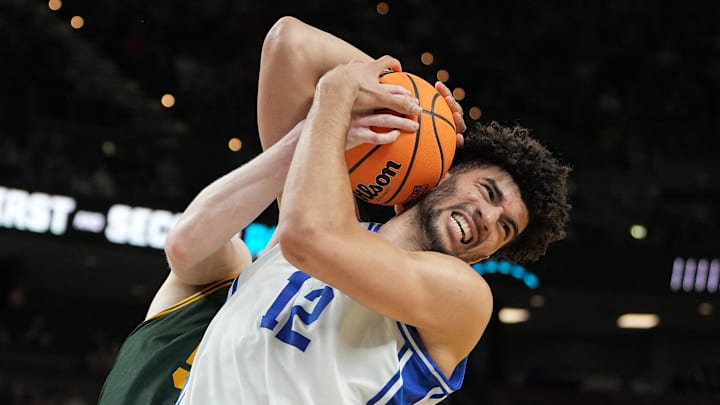 Mar 19, 2026; Greenville, SC, USA; Duke Blue Devils forward Cameron Boozer (12) reacts while getting a rebound against Siena Saints center Riley Mulvey (55) in the second half during a first round game of the men's 2026 NCAA Tournament at Bon Secours Wellness Arena. Mandatory Credit: Bob Donnan-Imagn Images