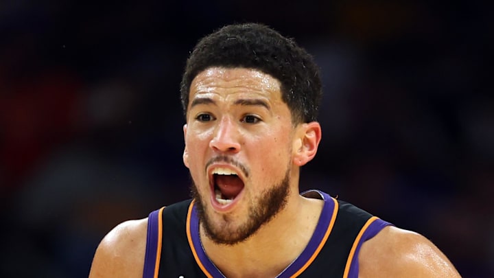 Apr 17, 2026; Phoenix, Arizona, USA; Phoenix Suns guard Devin Booker (1) reacts against the Golden State Warriors during the first half in the play-in rounds of the 2026 NBA Playoffs at Mortgage Matchup Center. Mandatory Credit: Mark J. Rebilas-Imagn Images
