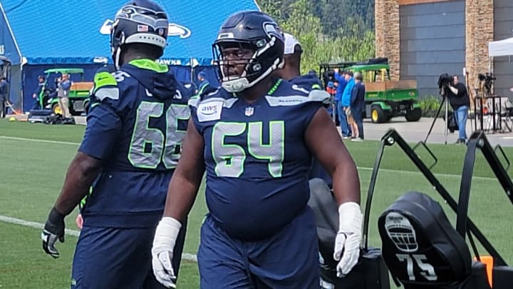 Seahawks rookie Christian Haynes listens to instructions from coach Scott Huff prior to a sled blocking drill at OTAs. Seahawks rookie Christian Haynes listens to instructions from coach Scott Huff prior to a sled blocking drill at OTAs.
