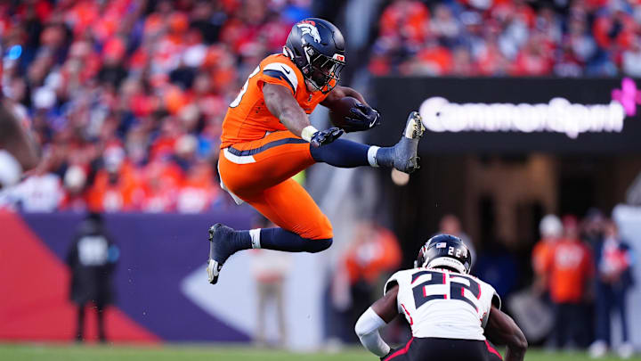 Denver Broncos running back Audric Estime (23) hurdles over Atlanta Falcons cornerback Clark Phillips III.