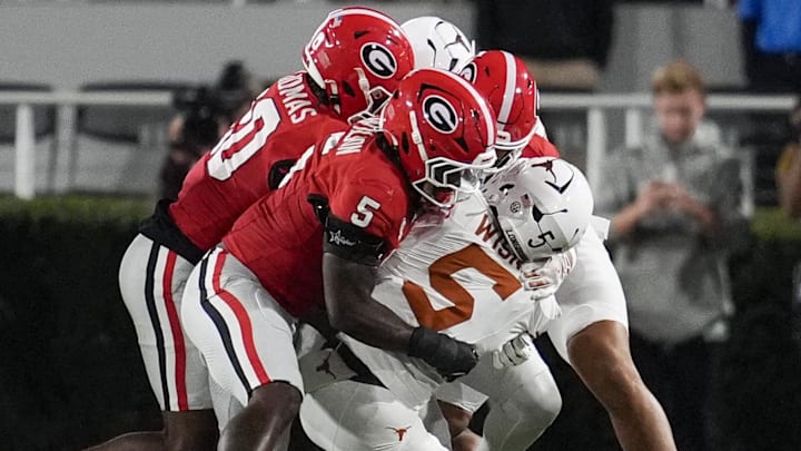 Georgia's college football players tackling a running back