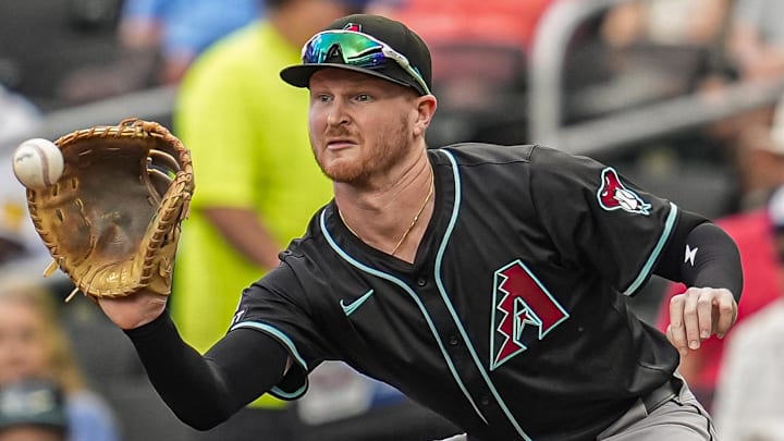Jun 5, 2025; Cumberland, Georgia, USA; Arizona Diamondbacks first baseman Pavin Smith (26) retires Atlanta Braves right fielder Ronald Acuna Jr (13) (not shown) during the first inning at Truist Park. Mandatory Credit: Dale Zanine-Imagn Images