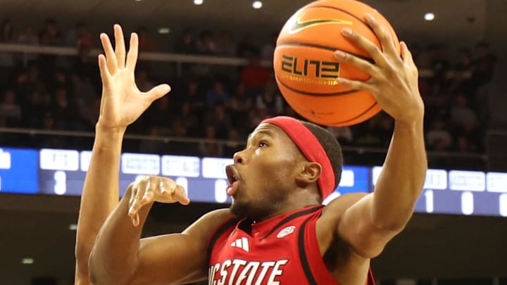 Dec 3, 2025; Auburn, Alabama, USA;  Auburn Tigers forward Filip Jovic (38) defends NC State Wolfpack guard Tre Holloman (5) during the first half at Neville Arena. Mandatory Credit: John Reed-Imagn Images