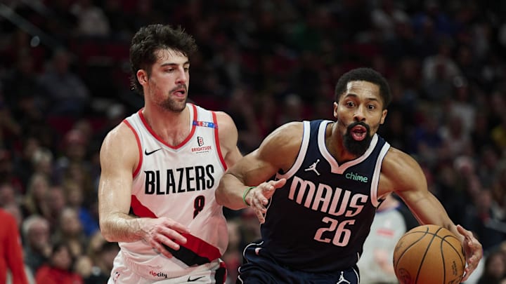 Dec 28, 2024; Portland, Oregon, USA; Dallas Mavericks guard Spencer Dinwiddie (26) drives to the basket during the second half against Portland Trail Blazers forward Deni Avdija (8) at Moda Center. Mandatory Credit: Troy Wayrynen-Imagn Images