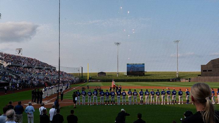 Fireworrks explode over the video screen during the National Anthem before a minor league baseball game between the Iowa Cubs and the St. Paul Saints Aug. 11, 2026 at the Field of Dreams in Dyersville, Iowa.