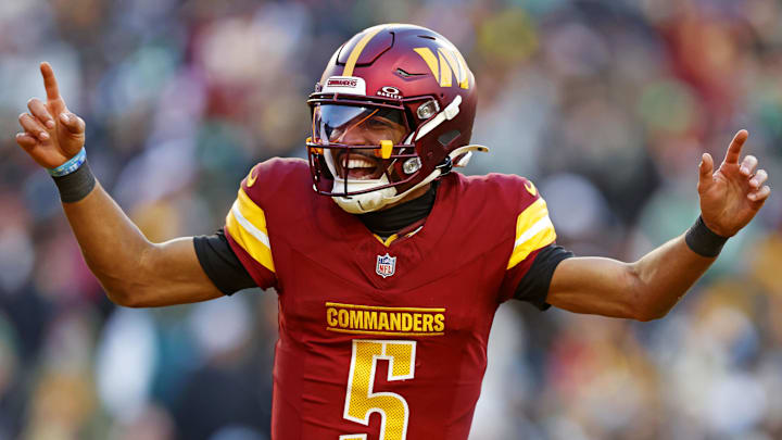 Dec 22, 2024; Landover, Maryland, USA; Washington Commanders quarterback Jayden Daniels (5) celebrates after throwing a touchdown during the fourth quarter against the Philadelphia Eagles at Northwest Stadium. Mandatory Credit: Peter Casey-Imagn Images