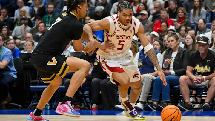 Arkansas Razorbacks guard Darius Acuff Jr. (5) drives to the basket past Vanderbilt Commodores guard Chandler Bing (7) during the first half during the men's SEC Conference Tournament Championship at Bridgestone Arena un Nashville, Tenn.