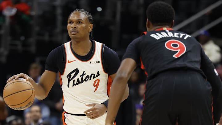 Detroit Pistons forward Ausar Thompson (9) dribbles defended by Toronto Raptors guard RJ Barrett (9) in the first half at Little Caesars Arena.