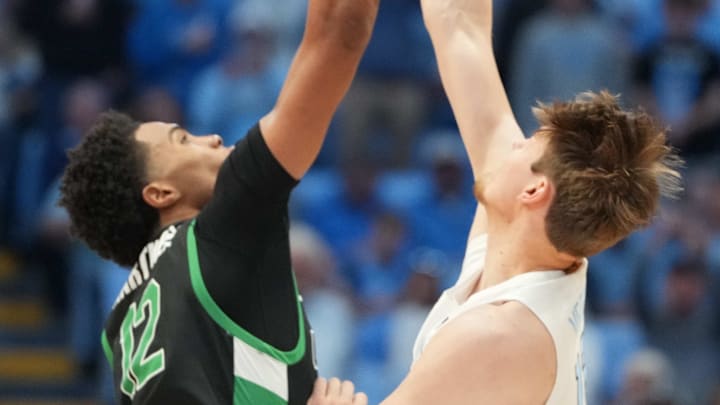 Dec 13, 2025; Chapel Hill, North Carolina, USA; USC Upstate Spartans forward Jafeth Martinez (12) and North Carolina Tar Heels center Henri Veesaar (13) during tip off at Dean E. Smith Center. Mandatory Credit: Bob Donnan-Imagn Images Dec 13, 2025; Chapel Hill, North Carolina, USA; USC Upstate Spartans forward Jafeth Martinez (12) and North Carolina Tar Heels center Henri Veesaar (13) during tip off at Dean E. Smith Center. Mandatory Credit: Bob Donnan-Imagn Images
