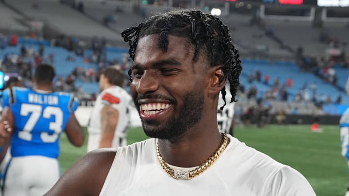 Aug 8, 2025; Charlotte, North Carolina, USA;  Cleveland Browns quarterback Shedeur Sanders (12) with Carolina Panthers wide receiver Jimmy Horn Jr. (15) after the game at Bank of America Stadium. Mandatory Credit: Bob Donnan-Imagn Images